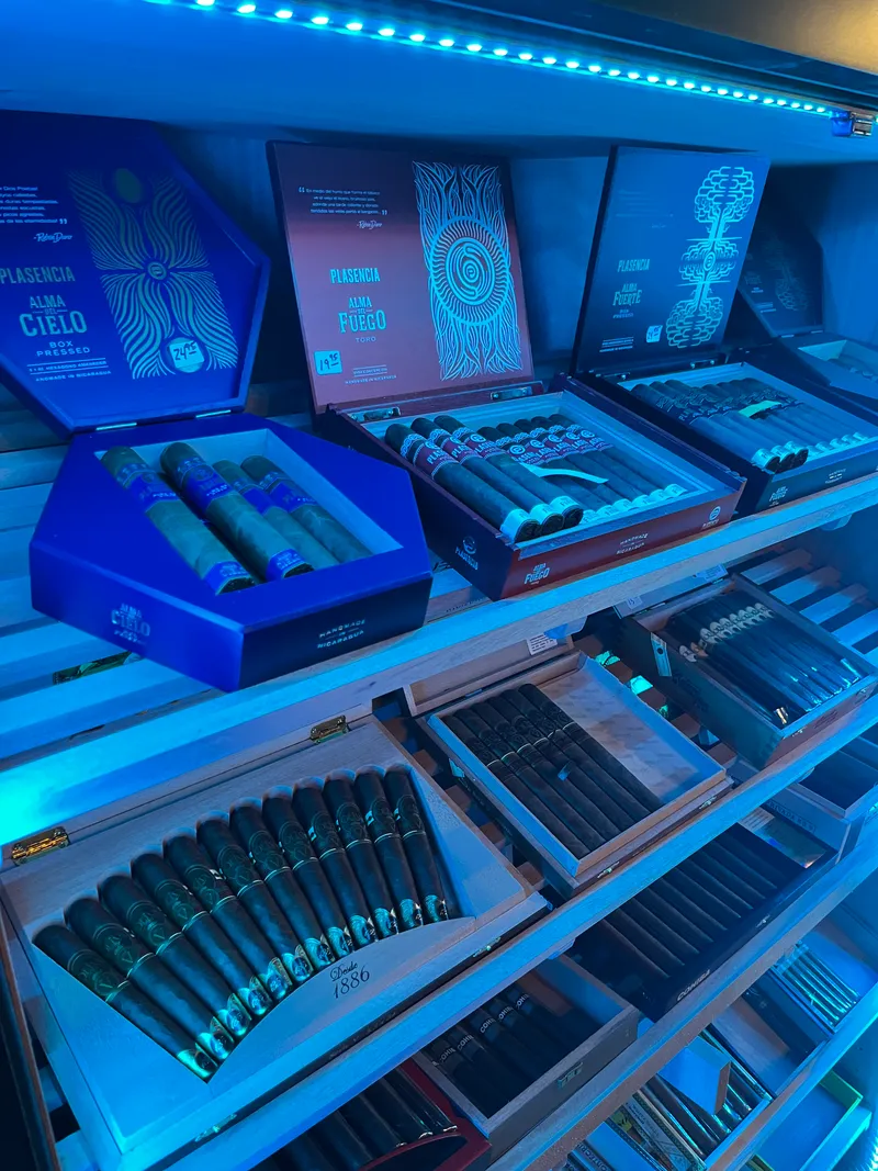 Open boxes of cigars on the humidor shelves